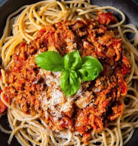 Ground Turkey Spaghetti with tomatoes sauce and fresh basil leaves with parmesan cheese