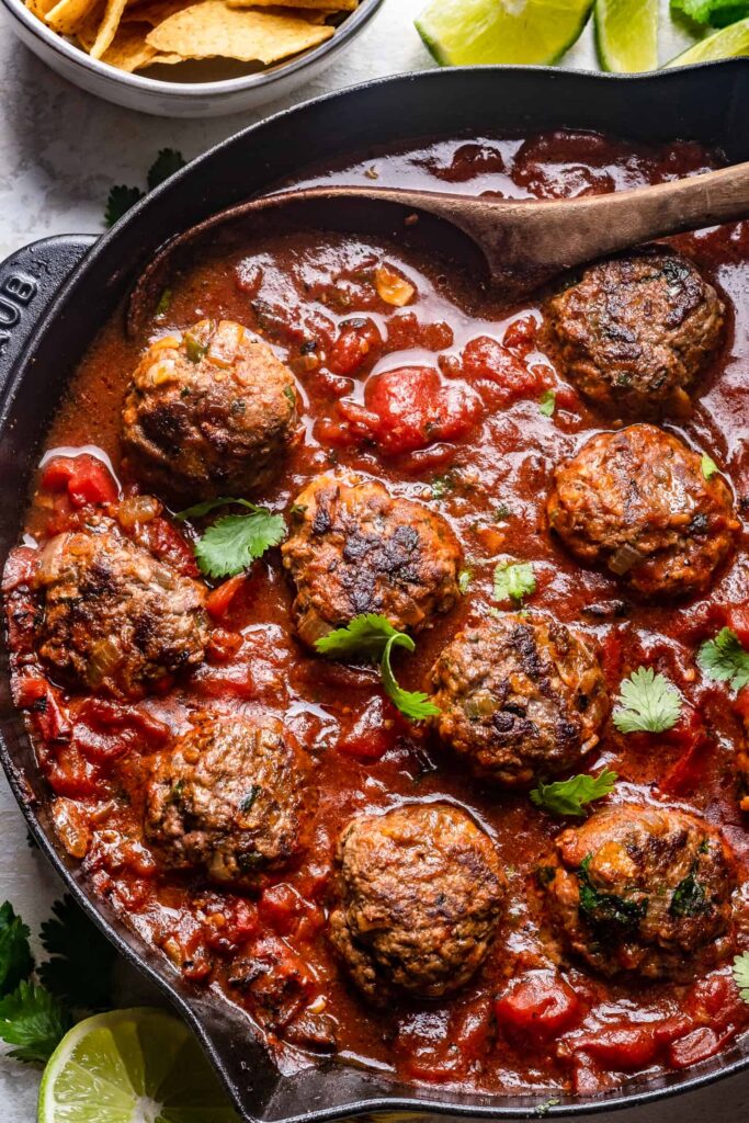 Homemade tex mex meatballs in tomato sauce topped with cilantro