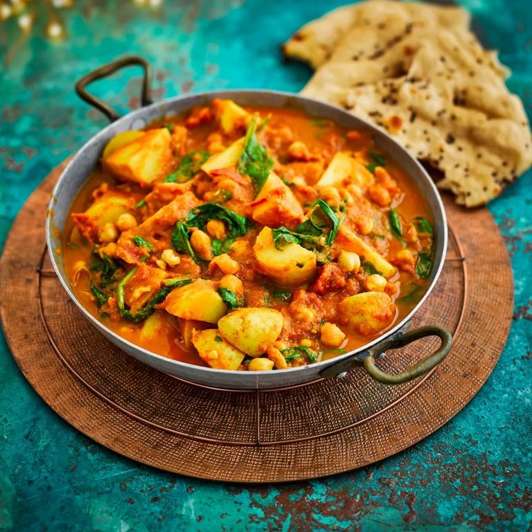Tasty chickpea curry with potatoes, spinach and tomato.  Serve it with naan.