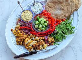 Delicious sheet pan chicken shawarma homemade served with fresh salad and pita bread