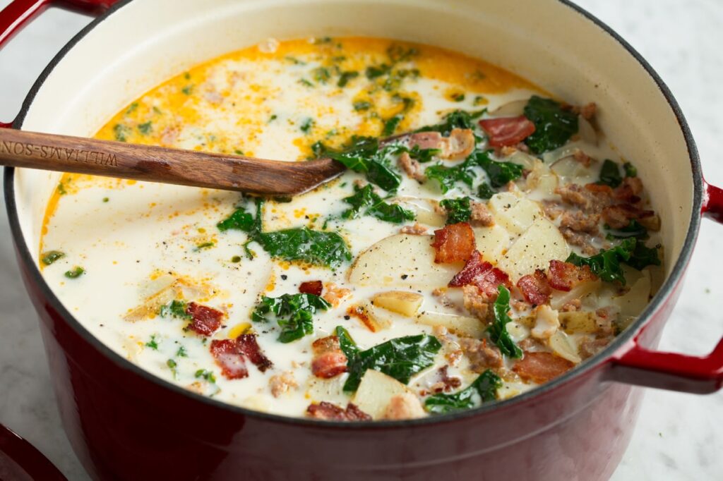 Homemade zuppa toscana soup in a cast iron pot.