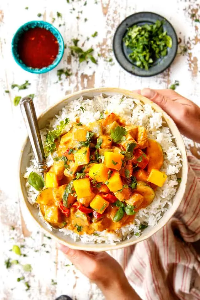 Delicious homemade mango chicken curry served with rice in a white bowl.