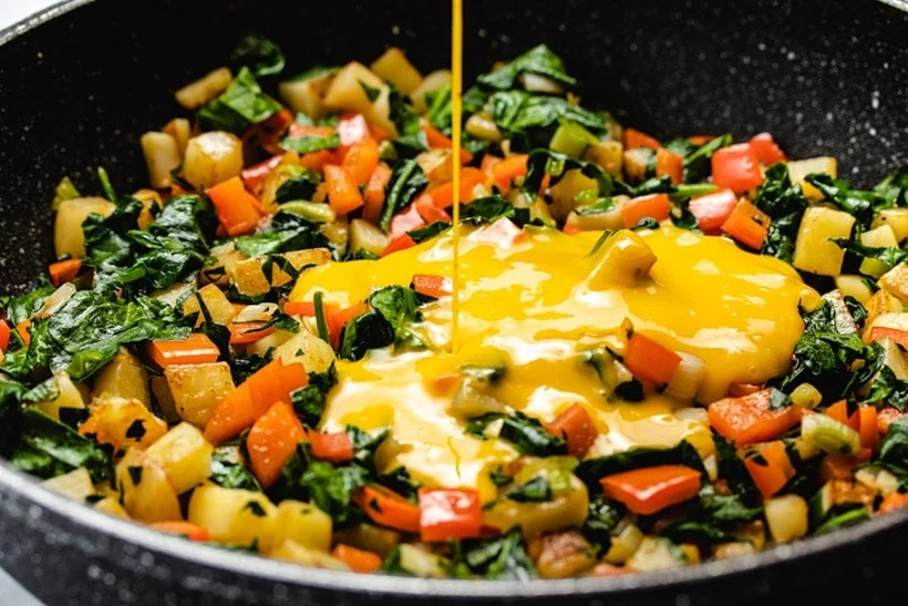 Making spinach and vegetables frittata the easy way in a skillet on low hear. Chopped vegetable and add the egg mix.