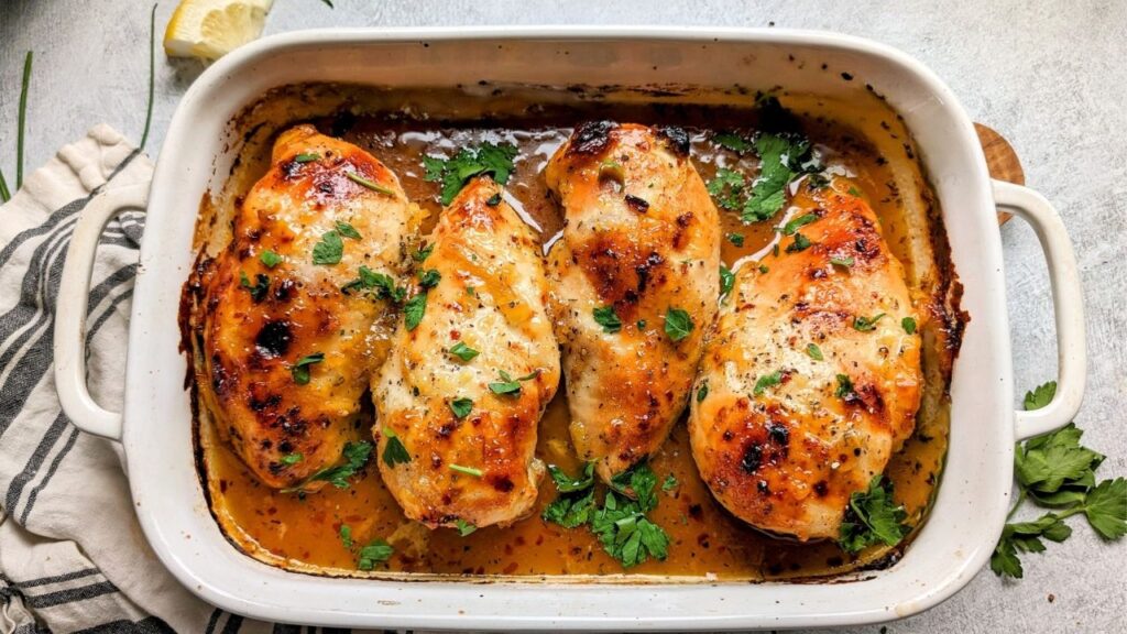Homemade Apricot chicken recipe ready in less than hour. Soft juicy apricot chicken served in a white rectangle oven dish on a table.